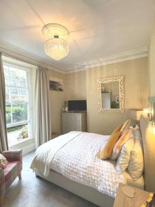 a bedroom with a bed and a mirror and a window at Sunny View in Aberystwyth