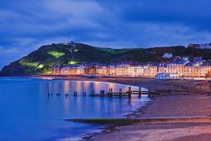 a town on the beach at night at Sunny View in Aberystwyth