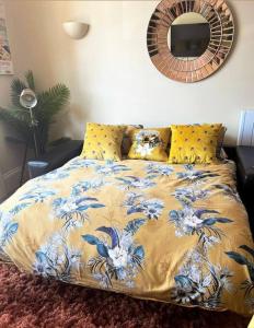 a bedroom with a bed with a blue and white blanket at Sunny View in Aberystwyth