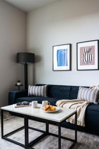 a living room with a blue couch and a coffee table at Kasa Archive Reno-Tahoe in Reno