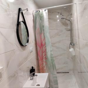 bagno con lavandino, doccia e specchio di Nest a Spišská Nová Ves