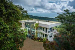 an aerial view of a house with trees at Amigos Por La Vida in Dominical