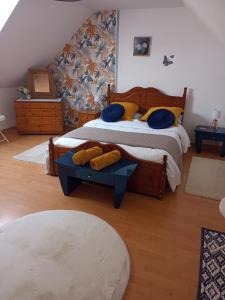 a bedroom with two beds with blue and yellow pillows at Four chimneys in Treffrin