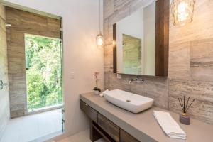 a bathroom with a sink and a mirror at RESOL Secluded Ocean-view luxury in the Jungle in Uvita