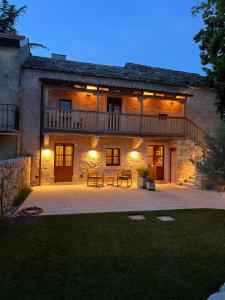a large house with a patio in front of it at Appartamenti Minerva in San Pelagio