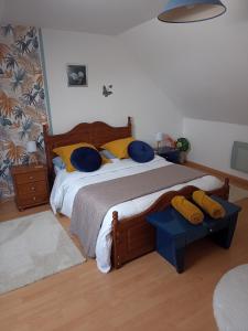 a bedroom with a bed with blue and yellow pillows at Four chimneys in Treffrin