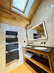 a bathroom with a sink and a mirror at Le Refuge Cal Chalon , chalet de luxe au cœur du village in Les Angles