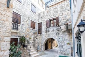 an alleyway in an old stone building with stairs at Stone House Srida in Baška Voda