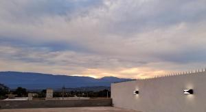 a building with a view of the mountains at Casa Valle Viejo con Cochera Cubierta Gratis in San Fernando del Valle de Catamarca