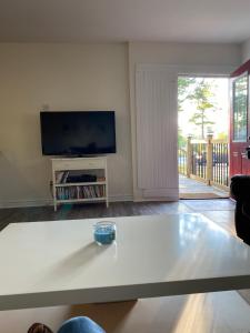 a living room with a table and a tv at 2 bedroom, sleeps 7 in Wasaga Beach in Wasaga Beach