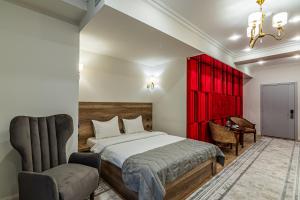 a bedroom with a bed and a red cabinet at Oscar Hotel by AG Hotels Group in Almaty
