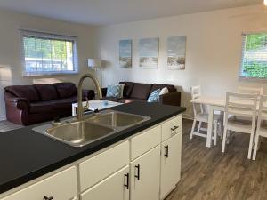 a kitchen with a sink and a living room at 2 bedroom, sleeps 7 in Wasaga Beach in Wasaga Beach