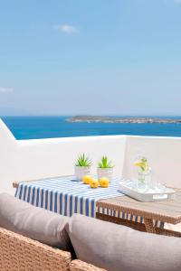 a table with a blue and white striped table cloth at Sealit Deluxe Apartment in Drios