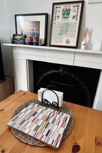 a table with a purse on top of a fireplace at 1 bedroom apartment in Shepherds Bush, London in London