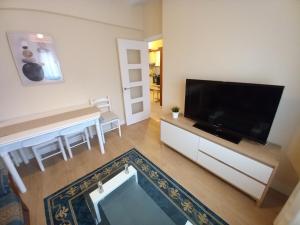 a living room with a large flat screen tv at Casa Anita in Luarca