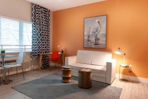 a living room with a white couch and a table at Oceanside Hotel and Suites in Miami Beach