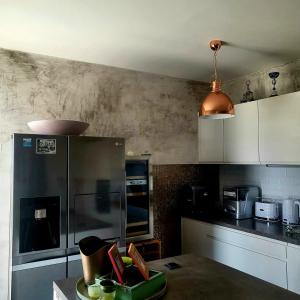 una cocina con nevera de acero inoxidable y armarios blancos en Holiday house in Split with sea view, terrace, air conditioning, WiFi 4937-1, en Solin