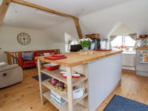 a kitchen with a wooden counter top in a room at Coach House in Ruthin