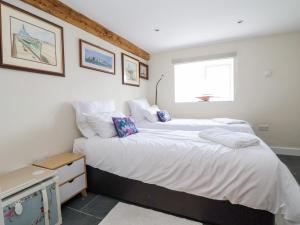 a bedroom with two beds and a window at Coach House in Ruthin