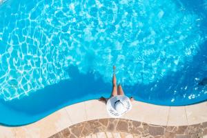 a person with a ball in a swimming pool at Apartments Villa Klaudia - Adults Only in Crikvenica