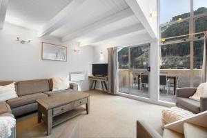 a living room with a couch and a table at Bluebird Stay in Queenstown