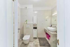 a white bathroom with a toilet and a sink at LUXURY MARIJANA APARTMENT in Privlaka +27 photos