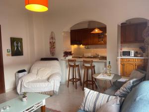 a living room with a couch and a kitchen at BestHomeStay- Caparica Beach Lisbon in Almada