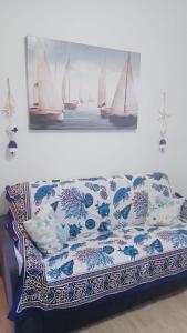 un sofá en una habitación con una foto de barcos en Domo Mea, en Miniera dellʼArgentiera