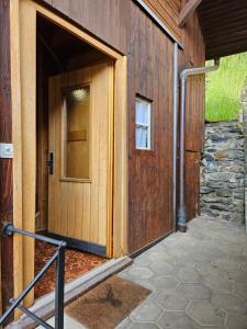 an open door of a building with a stone wall at Chalet Aargovia South in Wengen