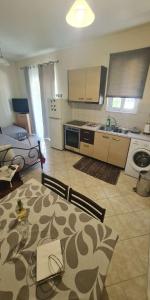 a kitchen with a table and a kitchen with a stove at Retas apartment in Kremasti