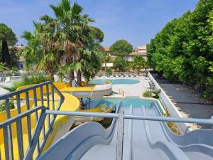 a slide at a resort with a swimming pool at Joli Mobil Home in Agde