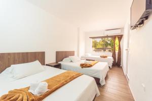Кровать или кровати в номере Hotel Dellhar Americano By Del Toro