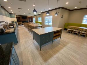 a large room with tables and chairs and tables at Country Inn & Suites by Radisson, Champaign North, IL in Champaign
