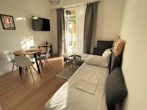 a living room with a couch and a table at Mediterra 2 in Crikvenica