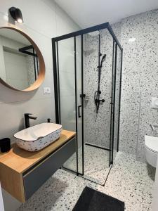 a bathroom with a glass shower and a sink at Mediterra 2 in Crikvenica
