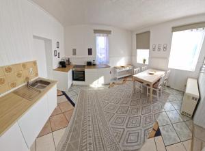 a large white kitchen with a table and a dining room at Ferienhaus Jena - Teamwork Holiday House 