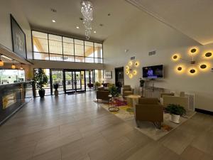 a large living room with chairs and a television in it at Super 8 by Wyndham Biloxi Ocean Springs in Ocean Springs