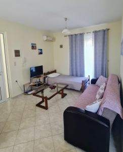 a living room with a couch and a table at Retas apartment up in Kremasti
