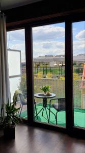 a view of a balcony with a table and chairs at Apartmán Jako doma in Olomouc