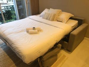 a large bed with two towels on top of it at Boulevard de la croisette PALAIS MIRAMAR in Cannes +15 photos
