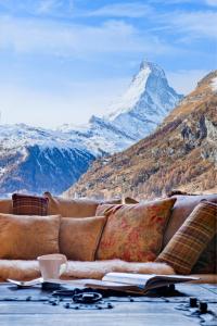 a couch with a view of a mountain at Chalet Grace in Zermatt
