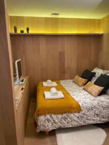 a small bedroom with a bed with towels on it at La pointe Cap ferret in Lège-Cap-Ferret