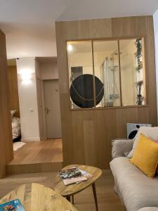 a living room with a couch and a large mirror at La pointe Cap ferret in Lège-Cap-Ferret