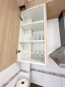 baño con armario lleno de gafas y aseo en Centro Apartamentos, en Alicante