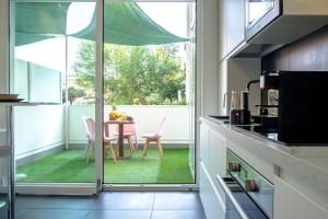 a kitchen with a table and chairs and a window at Enjoy Living in Pescara