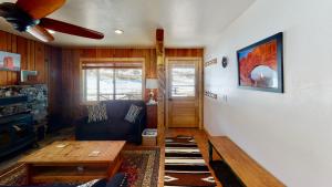 a living room with a couch and a ceiling fan at Pack Creek ~ Farm House in Moab