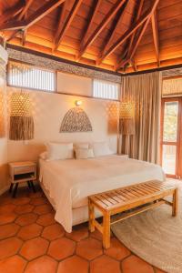 a bedroom with a large bed and a wooden ceiling at Rosario EcoHotel in Isla Grande