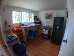 a kitchen with a black refrigerator and a sink at SALIMAR - Barra de Santiago in Barra de Santiago