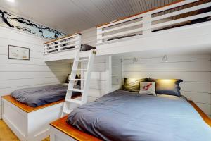 a bedroom with two bunk beds and a ladder at Lobster Shack in Boothbay