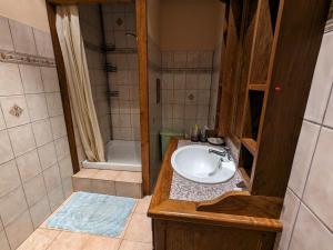 a bathroom with a sink and a shower at Maison de charme près de Neufchâteau avec jardin, terrasse et jeux extérieurs - FR-1-589-163 in Saint-Ouen-lès-Parey +22 photos